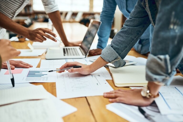 Business people, meeting and document with hands, statistics and social media trends on desk